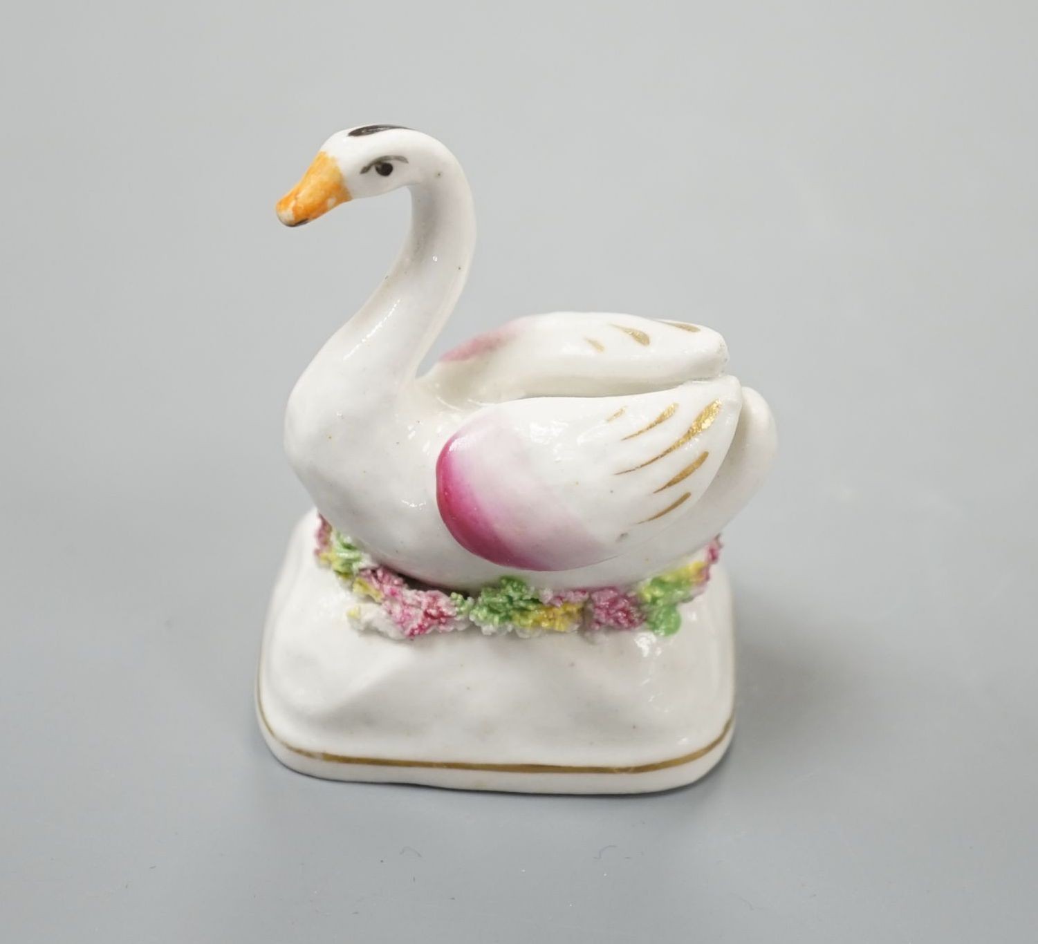 A Staffordshire porcelain model of a swan, c.1835-50, on a mound base, 5.4 cm high, Provenance: Dennis G.Rice collection